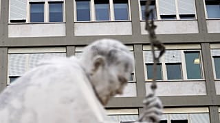 A marble statue of late Pope John Paul II is backdropped by the Agostino Gemelli Polyclinic in Rome, where Pope Francis was hospitalised in February 2025.