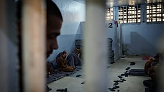 Inmates accused of being Islamic State (ISIS) fighters sit inside a cell at the Syrian Democratic Forces-run Gweiran Prison, in Hassakeh, northeastern Syria, 31 January 2025.