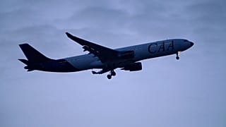 A Hi Fly Airbus A330 in CAA, Compagnie Africaine d'Aviation, livery approaches for landing in Lisbon, as night falls. 2 January 2025.