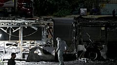 Israeli police inspect the scene of one of a series of bus explosions in what authorities said appeared to be a militant attack in Bat Yam, central Israel, Feb 20, 2025