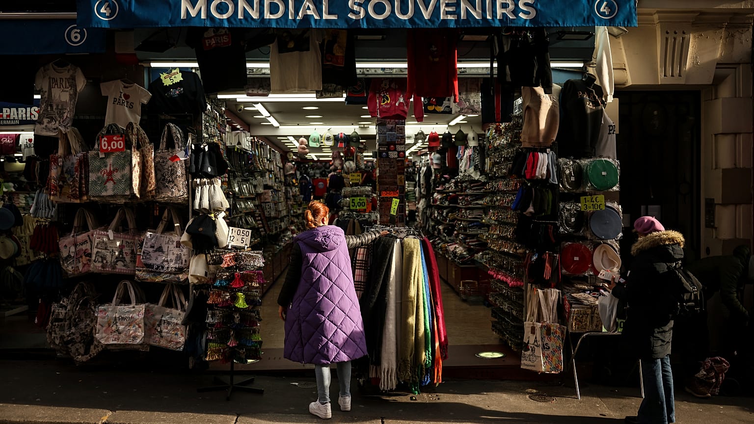 File photo of a woman looking at a souvenir shop of Montmartre during a cold day in Paris, Saturday, Jan. 5, 2025. 