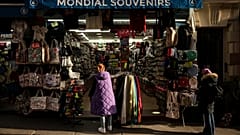 File photo of a woman looking at a souvenir shop of Montmartre during a cold day in Paris, Saturday, Jan. 5, 2025. 