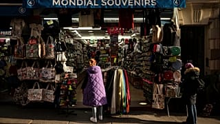 File photo of a woman looking at a souvenir shop of Montmartre during a cold day in Paris, Saturday, Jan. 5, 2025. 