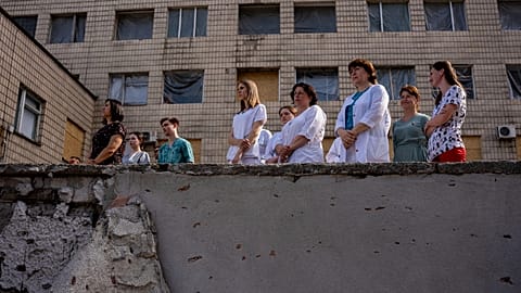 Medical workers stand by Okhmatdyt children's hospital in Kyiv, the site of the Russian missile attack in July 2024.