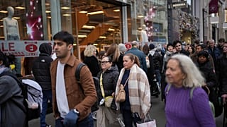 File photo of people passing a shop advertising for post-Christmas sales on Oxford Street in London, Monday, Dec. 30, 2024. 