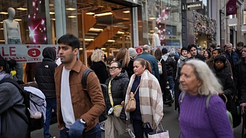 File photo of people passing a shop advertising for post-Christmas sales on Oxford Street in London, Monday, Dec. 30, 2024. 