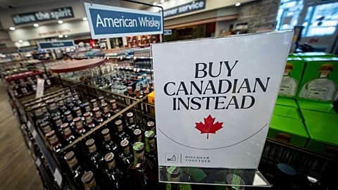 A sign is placed in front of the American whiskey section at a B.C. liquor store after top selling American made products have been removed from shelves in Vancouver, B.C.,