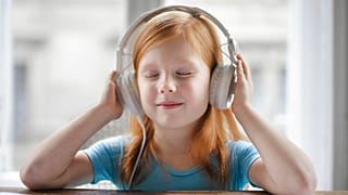 A young girl listens to 'One Day in the Life of Ivan Denisovich' by Aleksandr Solzhenitsyn