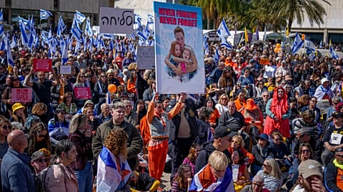 Le persone assistono alla trasmissione in diretta del funerale di Shiri Bibas e dei suoi due figli, Ariel e Kfir, nella Piazza degli ostaggi a Tel Aviv, Israele, il 26.02,2025