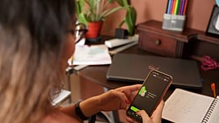 A woman with the Duolingo app open on a smartphone. 