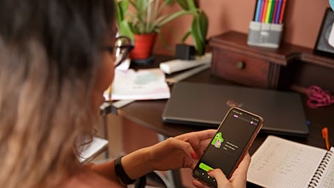 A woman with the Duolingo app open on a smartphone. 