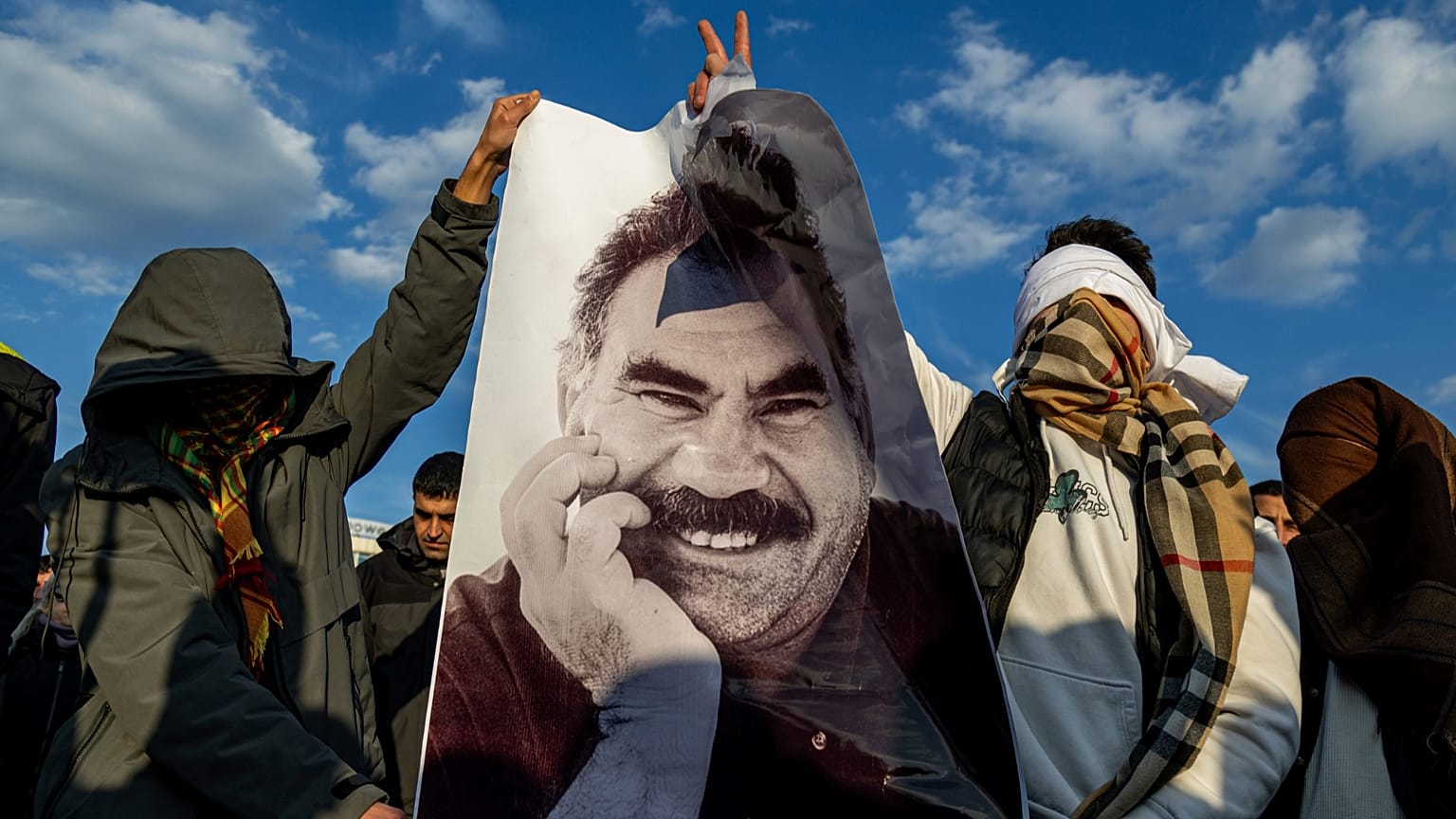 Youngsters hold a photograph of PKK's Abdullah Ocalan, in Diyarbakir, 27 February 2025