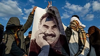 Youngsters hold a photograph of PKK's Abdullah Ocalan, in Diyarbakir, 27 February 2025