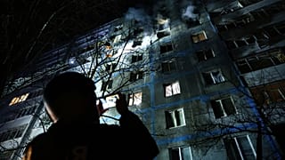 Un soccorritore fotografa un edificio a più piani danneggiato da un attacco di un drone russo su un quartiere residenziale di Zaporizhzhia, 28 febbraio 2025