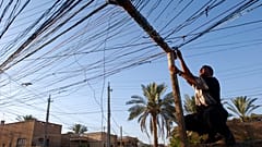 ده ها کابلی که خانه‌های محله را به ژنراتوری در بغداد وصل می‌کند، ۲۰۰۴ میلادی 
