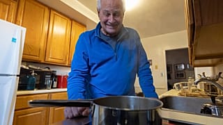 Ed Yaker boils water on an electric induction stove