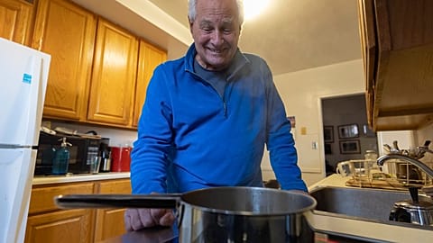 Ed Yaker boils water on an electric induction stove