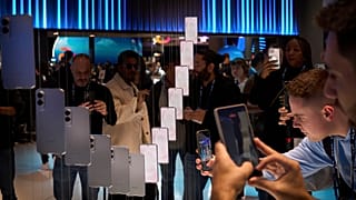 Visitors take pictures of the newly introduced phone the Galaxy S25 Edge, during the Mobile World Congress in Barcelona, Spain, Monday, March 3, 2025