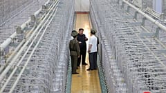 Kim Jong Un, ortada, Kuzey Kore'de açıklanmayan bir yerde bir nükleer silah enstitüsü ve nükleer malzeme tesisi olduğunu söyledikleri bir teftiş ziyaretinde.