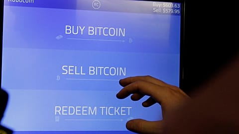 Bitcoin golden physical coin illustration on United States Dollar banknotes. FILE PHOTO