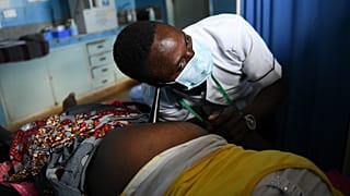 Une sage-femme écoute les battements de cœur d'un bébé à naître dans un centre de santé du sud du Malawi en mai 2021.