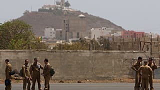 FILE - Members of a French military flight crew talk on the tarmac at France's military air base in Dakar, Senegal, Tuesday, June 2, 2009