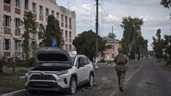 FILE - A Ukrainian soldier walks past a building in Sudzha, Kursk region, Russia, on Aug. 16, 2024.