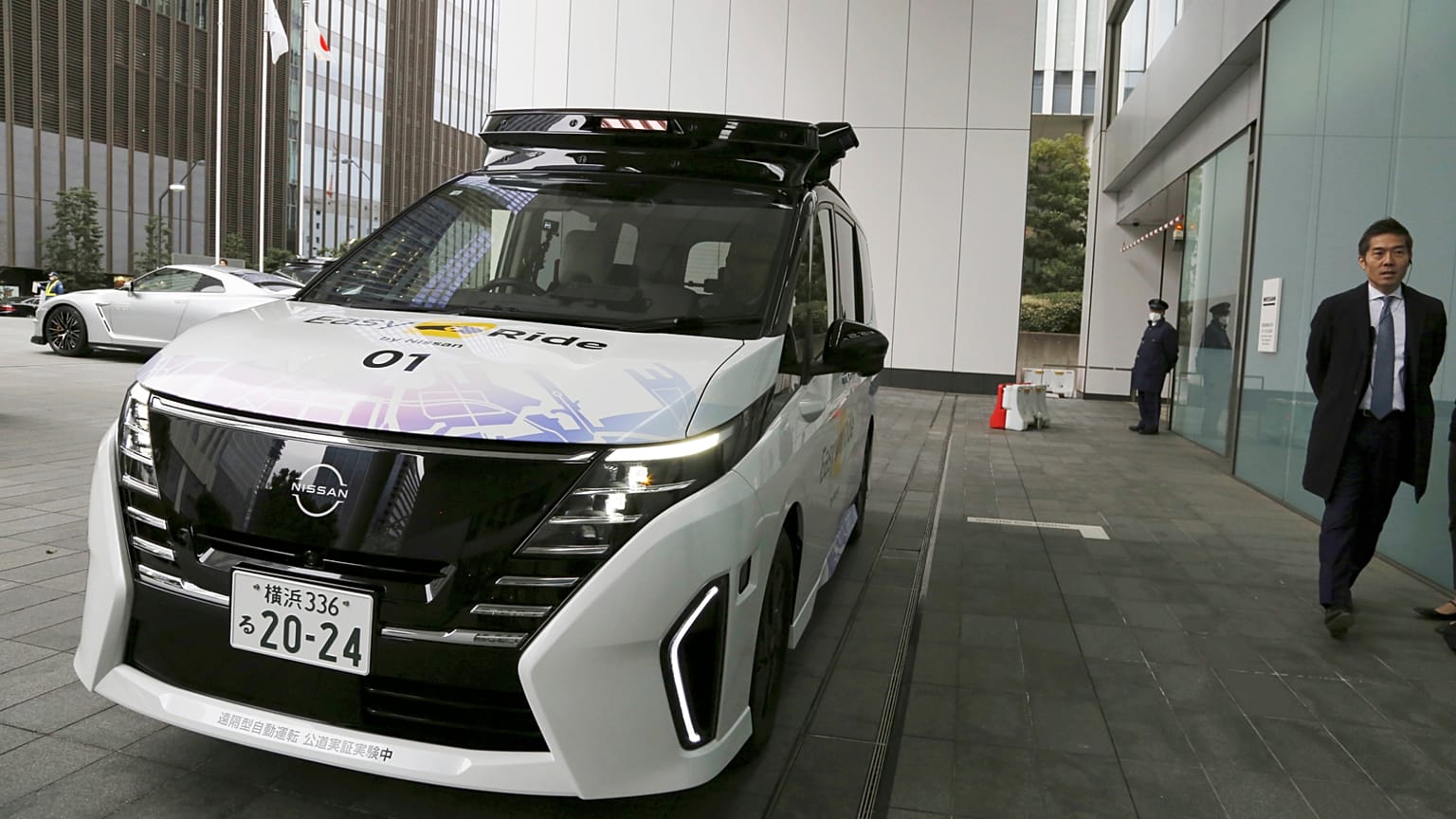 Nissans selbstfahrendes Auto fährt am 6. März 2025 in Yokohama, nahe Tokio, in eine Demonstration für Reporter vom Straßenrand in den Eingang des Hauptquartiers.