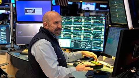 People work on the floor at the New York Stock Exchange in New York, Tuesday, March 4, 2025. 