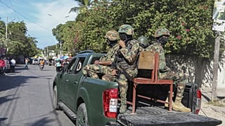 FILE: Soldiers patrol a street in Port-au-Prince, Haiti, Monday, Dec. 2, 2024