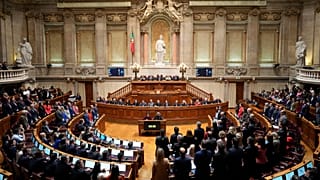 Members of opposition parties stand to vote against a government confidence motion at the Portuguese parliament in Lisbon, 11 March, 2025