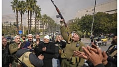 Σύροι μαχητές πανηγυρίζουν στη Δαμασκό μετά την πτώση του καθεστώτος του Μπασάρ αλ Άσαντ, 8 Δεκεμβρίου 2024.