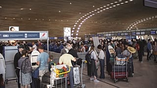 People wait in line at the airport.