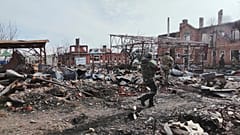 Des soldats russes marchent entre les ruines de Sudzha, la plus grande ville de la région de Koursk après sa reprise par les troupes russes, jeudi 13 mars 2025.