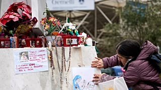 A person leaves a note wishing Pope Francis a speedy recovery in front of the Gemelli hospital in Rome, March 2025