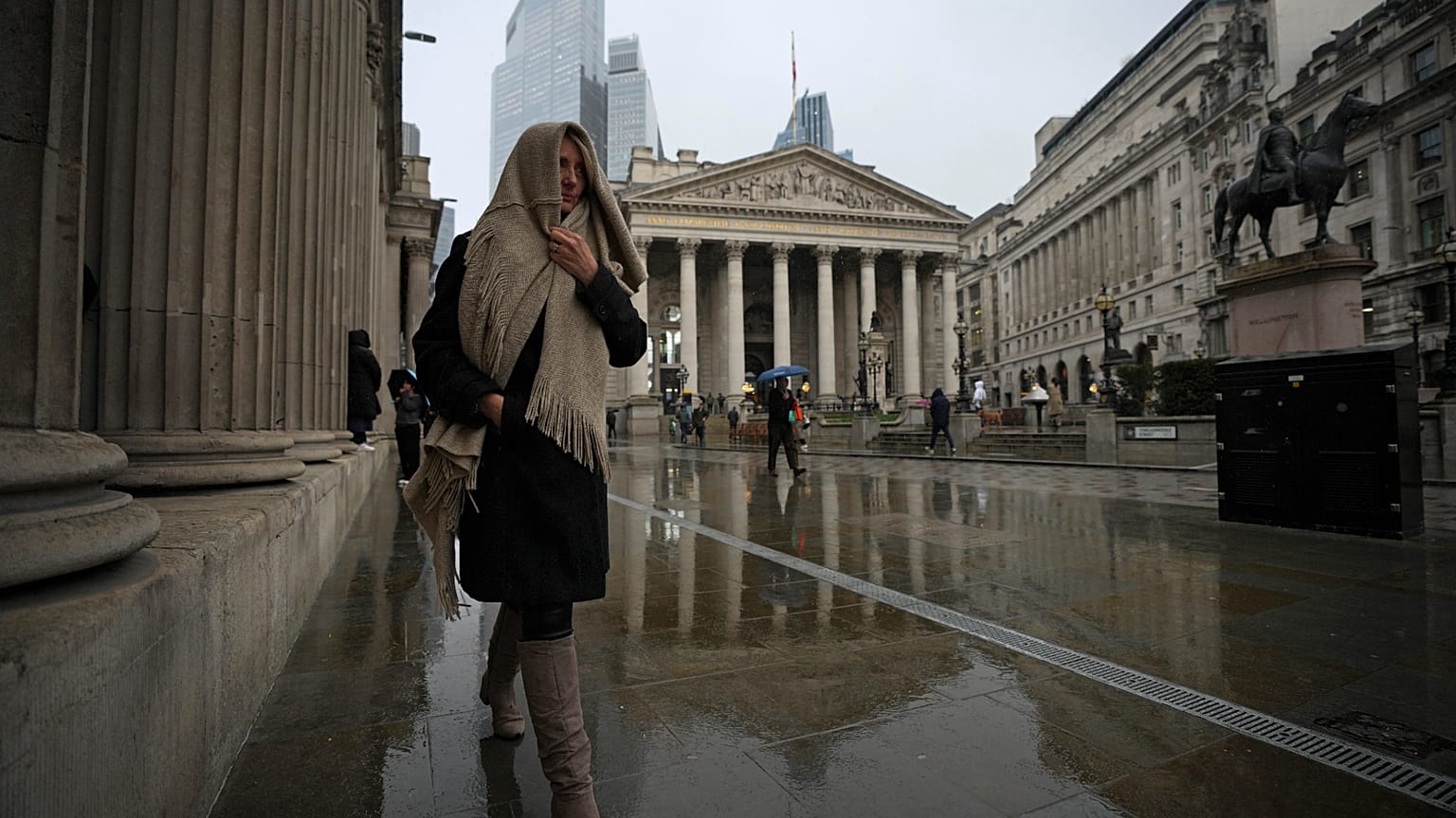 A woman walks past the Bank of England, at the financial district, in London. 13 March 2025.
