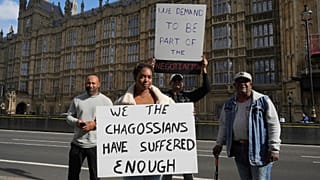 FILE - Chagossians Whitney Tranquille attends a protest outside the House of Parliament, in London, 7 October 2024.,