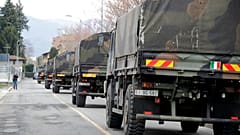 In this March 26, 2020 file photo, military trucks moving coffins of deceased people leave the cemetery of Bergamo