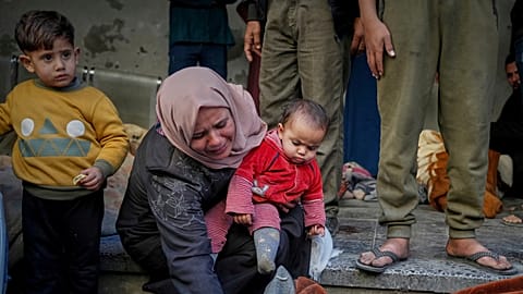 Une femme pleure alors qu'elle identifie un corps à l'hôpital Al-Ahli suite aux frappes aériennes israéliennes de la nuit précédente dans la bande de Gaza, à Gaza, le mardi 18 mars 2025.