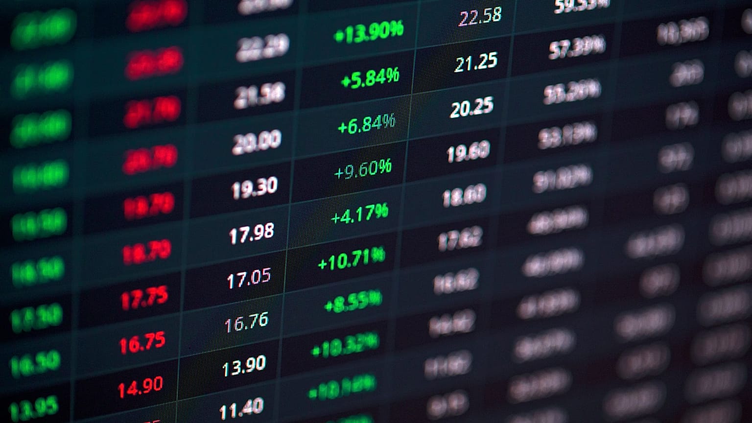 A stock market screen showing green and red indicators. 