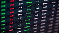 A stock market screen showing green and red indicators. 