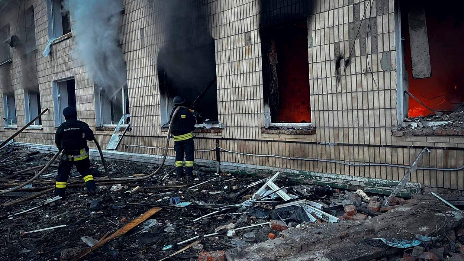 In this photo provided by the Ukrainian Emergency Service on Wednesday, March 19, 2025, firefighters work on a site of a Russian attack in Krasnopillia, Sumy region, Ukraine. 