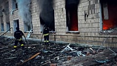 In this photo provided by the Ukrainian Emergency Service on Wednesday, March 19, 2025, firefighters work on a site of a Russian attack in Krasnopillia, Sumy region, Ukraine. 