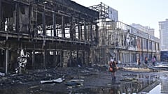 Municipal workers clean up after Russian drones hit shops during a night attack in Odesa, 21 March, 2025