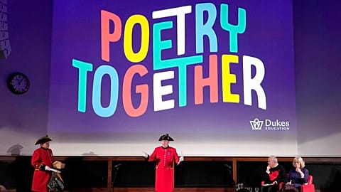 Britain's Camilla, the Duchess of Cornwall, right,and Gyles Brandreth, founder of Poetry Together, listen to poetry whilst joining children and care home residents