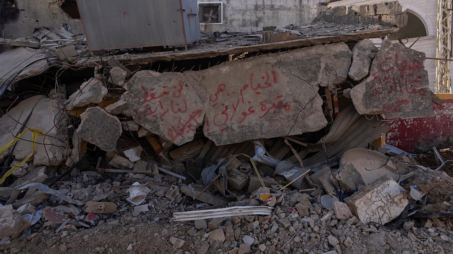 Arabic graffiti on a house destroyed by the Israeli air and ground offensive reads, "We will not be humiliated" in the southern town of Khiam, southern Lebanon, Monday, Feb. 1