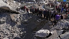 Palestinians inspect the site hit by Israeli bombardment in Gaza City, 23 March 2025
