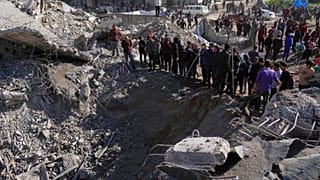 Palestinians inspect the site hit by Israeli bombardment in Gaza City, 23 March 2025