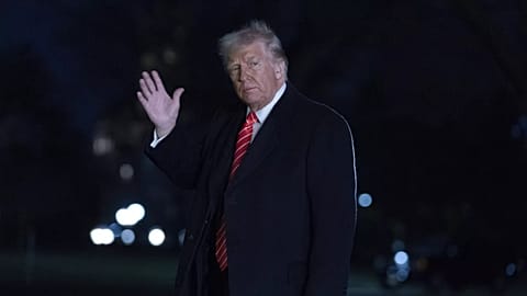 President Donald Trump waves to the media as he walks on the South Lawn of the White House, in Washington, Saturday, March 22, 2025
