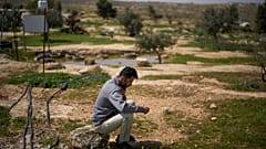 Basel Adra, um dos realizadores do documentário vencedor do Óscar "No Other Land", fala ao telefone perto da casa do co-realizador palestiniano Hamdan Ballal